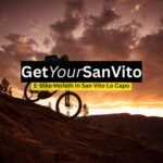 E-Bike-Fahrer bei Sonnenuntergang in einer bergigen Landschaft, symbolisch für den E-Bike-Verleih in San Vito Lo Capo und Ausflüge durch die Natur Siziliens.